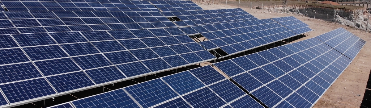 Aerial view of close up solar power panels, in desert. 